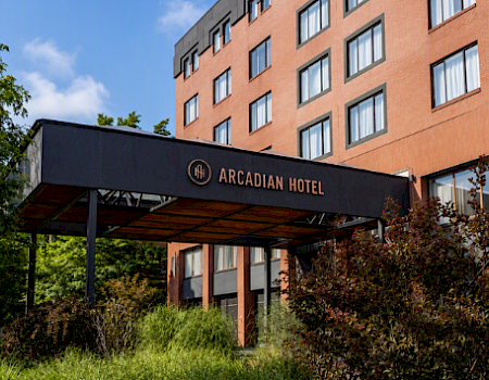 A collage showing a “1200 Beacon Street Motor Hotel” brochure, the “Arcadian Hotel” building sign, and a “1200 Special” roast prime rib menu.