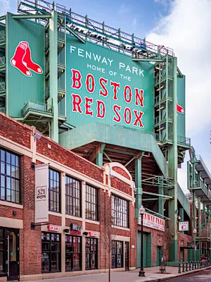 Fenway Park scoreboard shows “Home of the Boston Red Sox” with a red sock icon on the green structure.