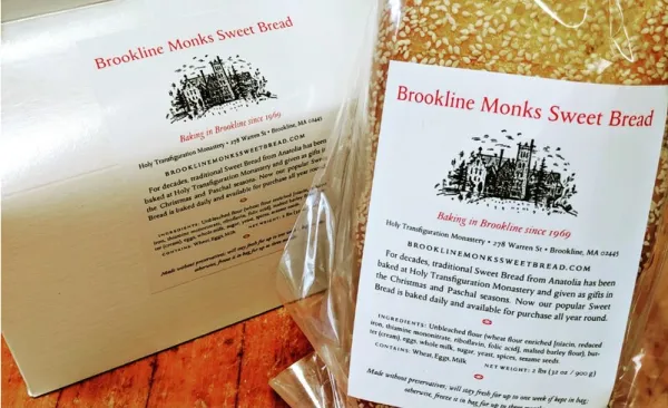 Two packages of Brookline Monks Sweet Bread with printed labels and a sesame-topped loaf visible inside.